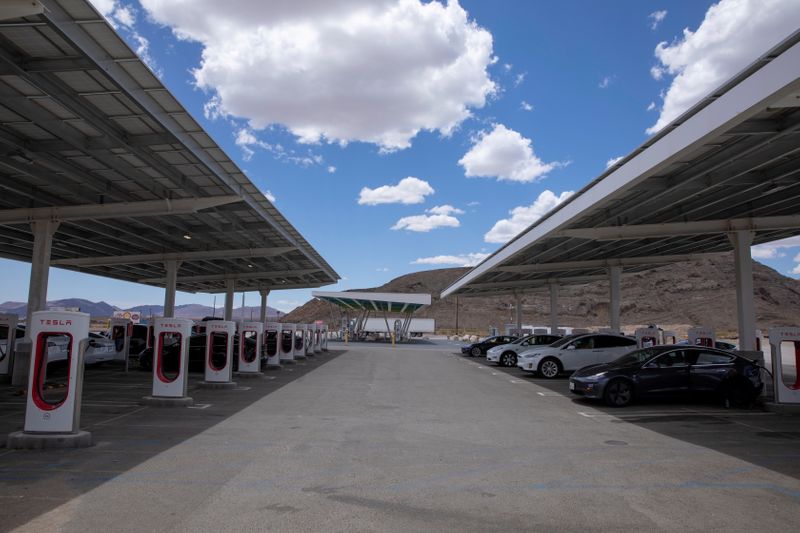 FILE PHOTO: Tesla electric vehicles recharge at a large supercharging