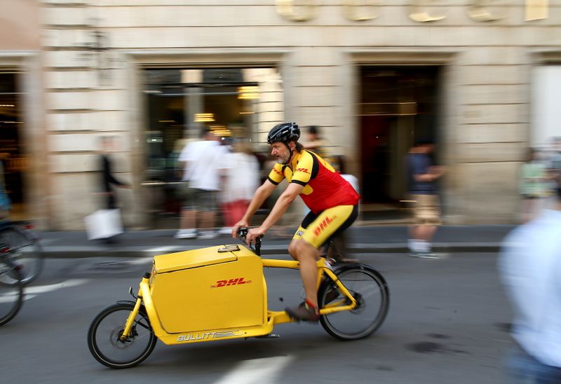 FILE PHOTO: A DHL bike messenger rides in central Rome