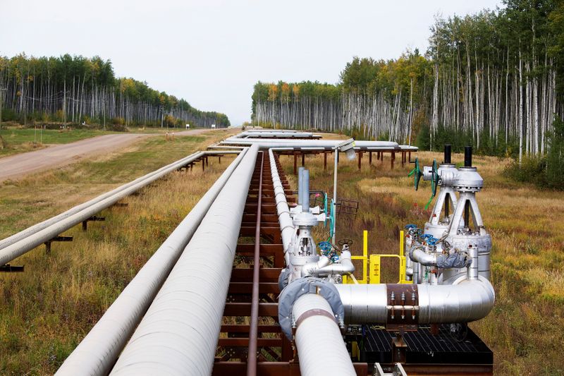 FILE PHOTO: Pipelines run at the McKay River Suncor oil
