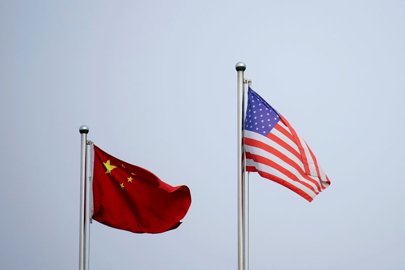 Chinese and U.S. flags flutter outside a company building in