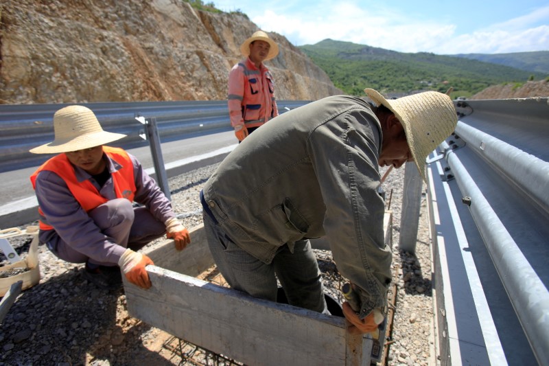 FILE PHOTO: Workers fit a manhole on Bar-Boljare highway