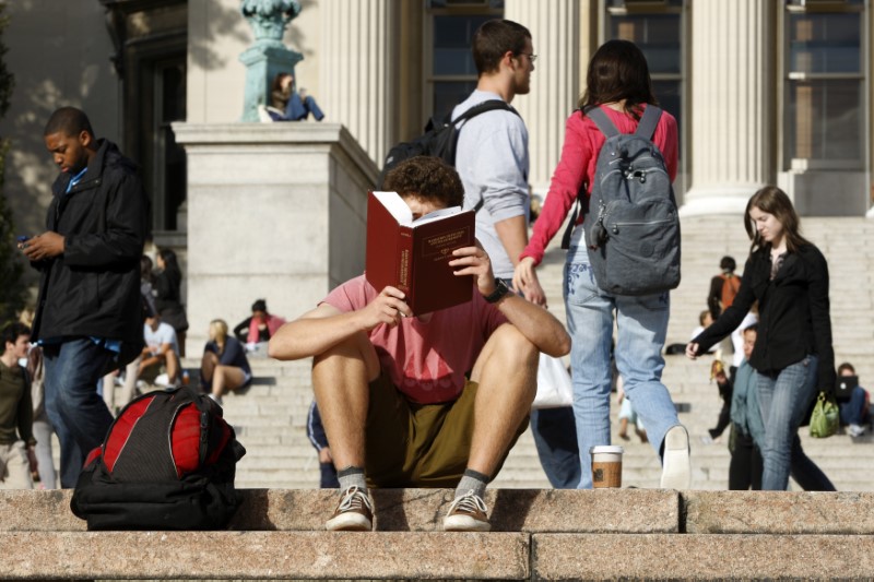 Student reads on the campus of Columbia University in New