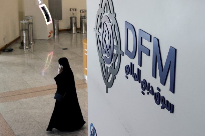 FILE PHOTO: A woman walks through the Dubai Financial Market