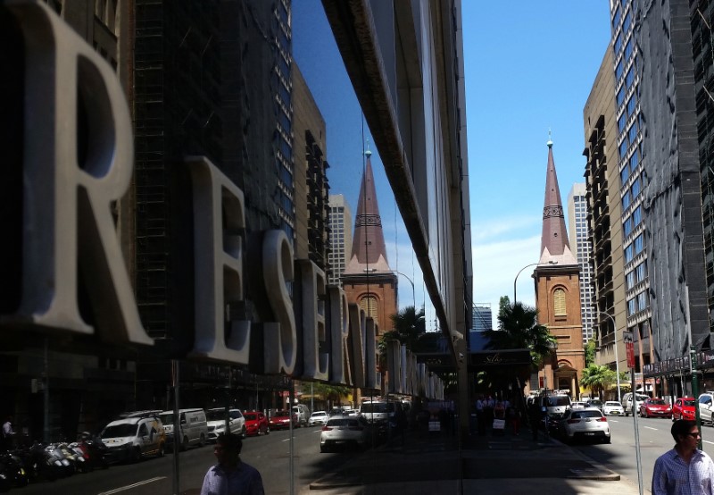 FILE PHOTO: Pedestrians walk past the Reserve Bank of Australia