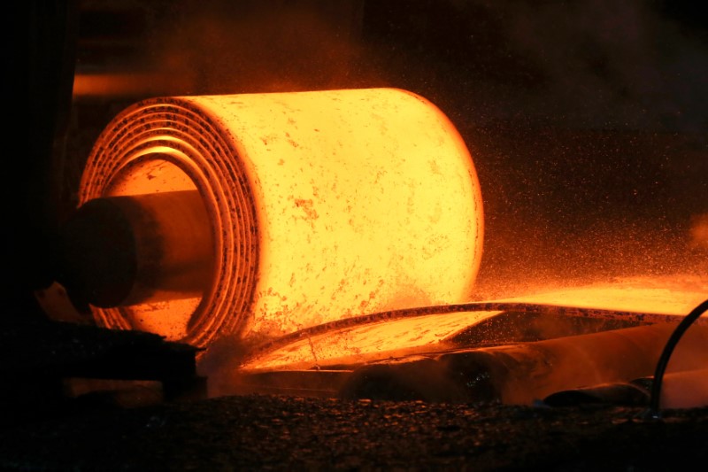 A steel coil is unrolled on the line at the