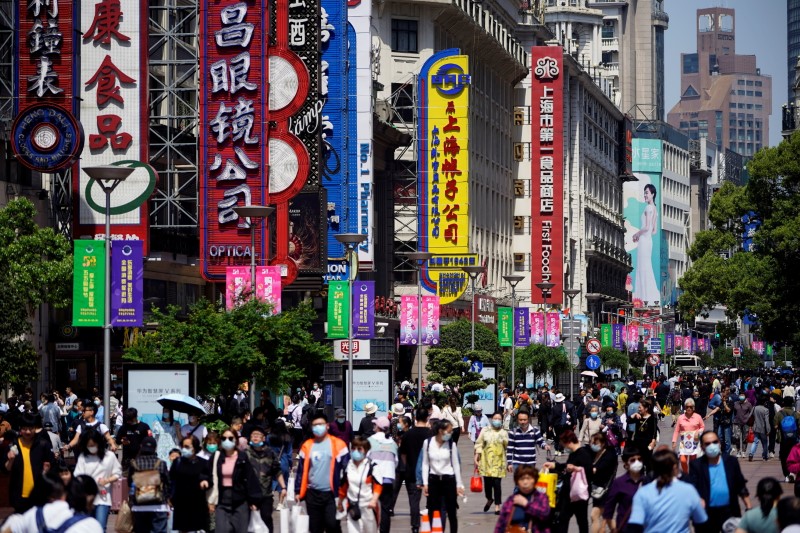 FILE PHOTO: People walk along Nanjing Pedestrian Road during the