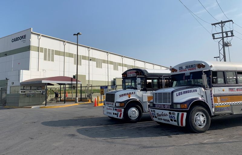 FILE PHOTO: Commuter buses are parked outside the Tridonex auto-parts
