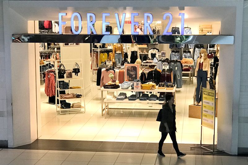 A shopper walks from a Forever 21 fashion retail store