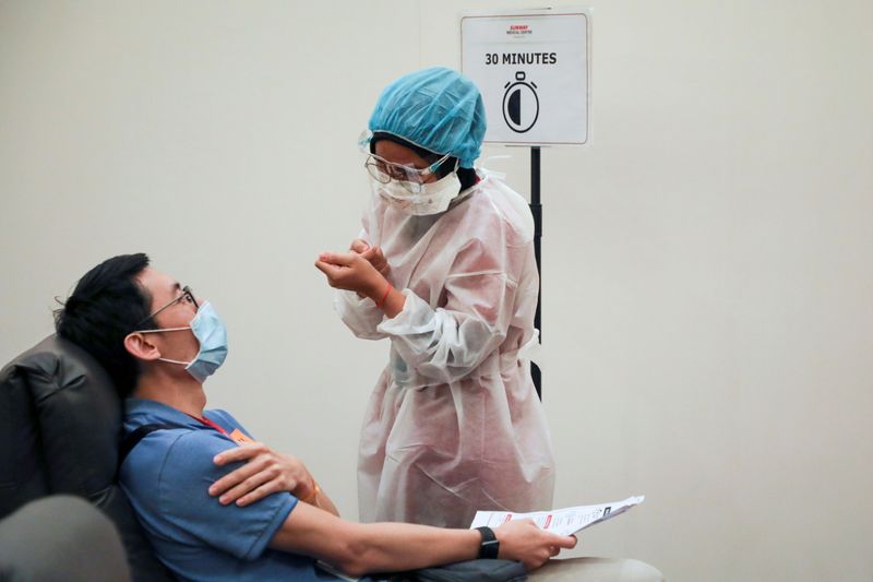 FILE PHOTO: A medical worker speaks to a man under