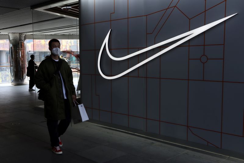 FILE PHOTO: Man walks past a Nike Inc store at