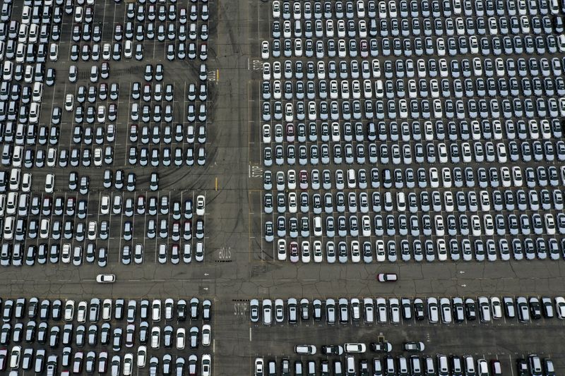New cars are seen lined up next to the dock