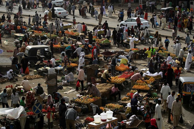 FILE PHOTO: Sudanese residents shop in a bazaar in Khartoum