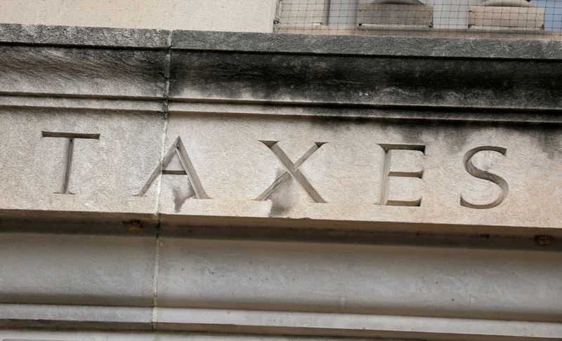 FILE PHOTO: The word “taxes” is seen engraved at the