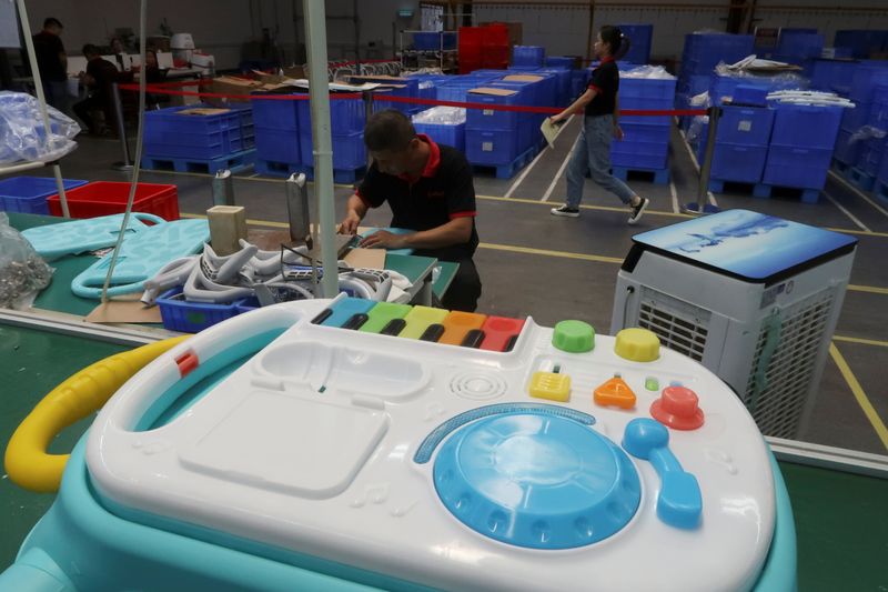 Employees work on the production line of Kids II Inc