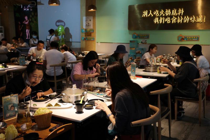 FILE PHOTO: People dine at a hotpot restaurant in Sanya