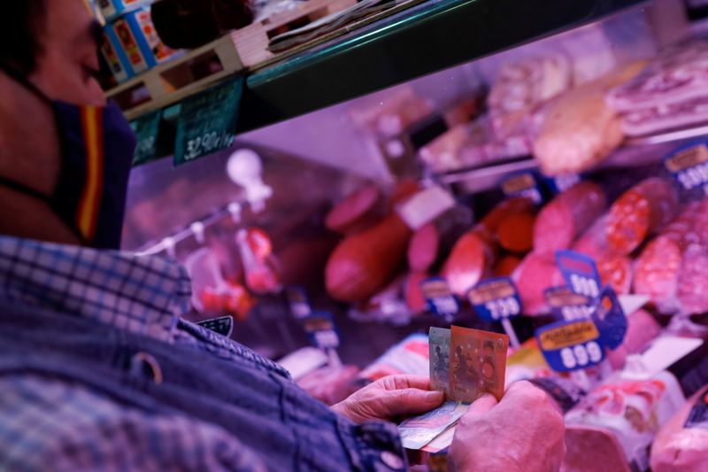 FILE PHOTO: A man wearing a face mask shops at