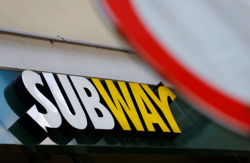 The logo of Subway fast food chain is seen behind