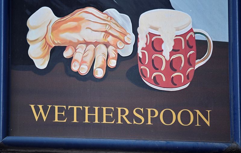 FILE PHOTO: A Wetherspoon’s logo is seen at a pub