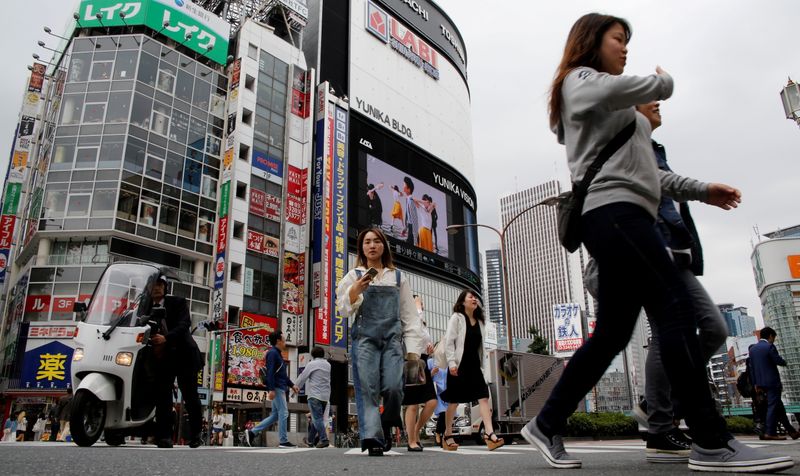 FILE PHOTO: People cross a street in the Shinjuku shopping
