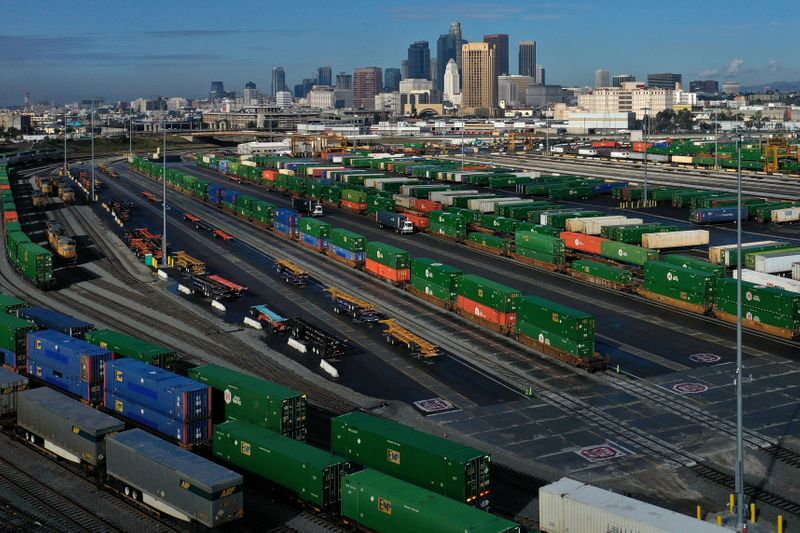 Shipping containers sit on train tracks downtown as the spread
