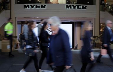 Shoppers walk outside a Myer department store, Australia’s largest department