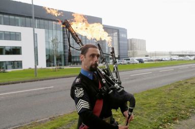 FILE PHOTO: A man plays flaming bag pipes as opponents