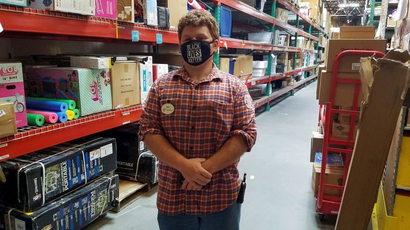 Target worker Adam Ryan stands in the stockroom of his