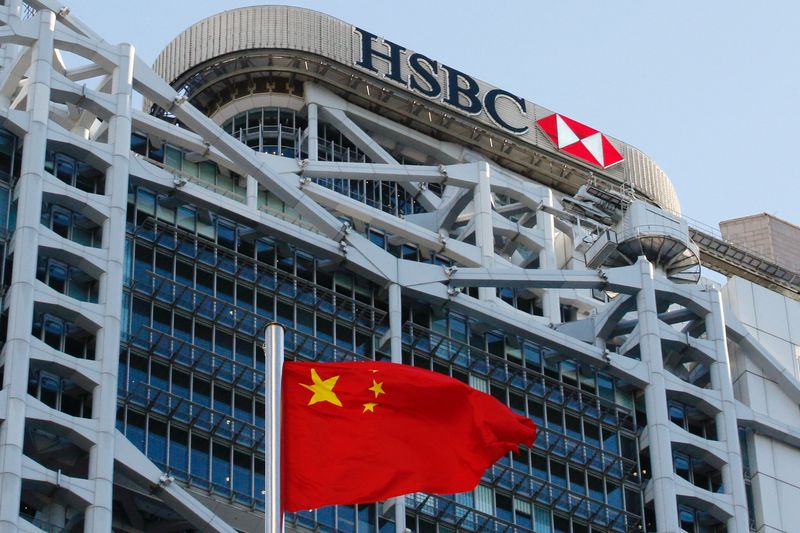 A Chinese national flag flies in front of HSBC headquarters