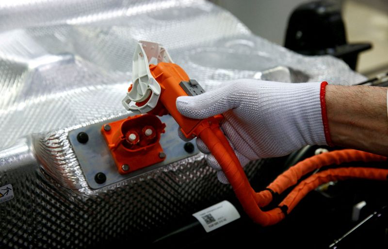 FILE PHOTO: Worker connects the battery during the assembly of