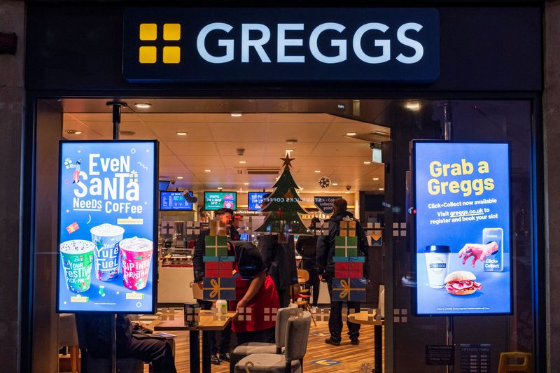 A Christmas themed window display at a branch of Greggs