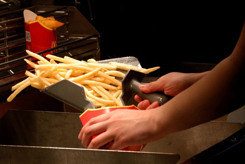 FILE PHOTO: An employee cooks French fries at a McDonald’s