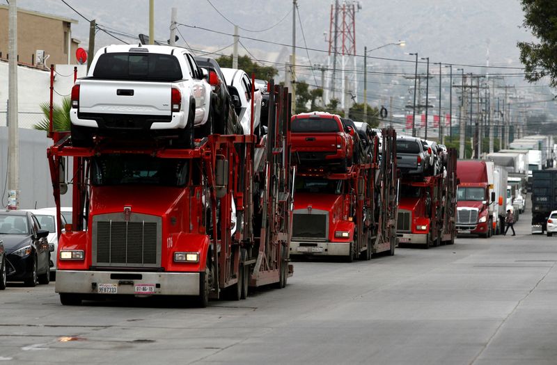 FILE PHOTO: A carrier trailer transports Toyota cars for delivery