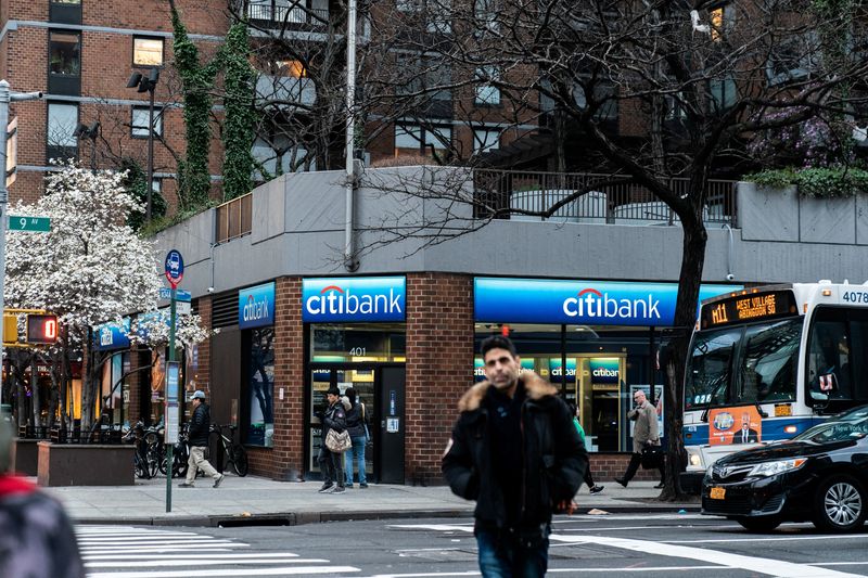 FILE PHOTO: People walk past Citi bank branch in New