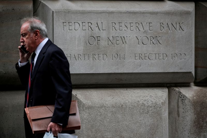 FILE PHOTO: A man walks outside the Federal Reserve Bank