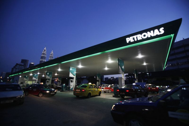 Motorists queue to fill natural gas at a Petronas station
