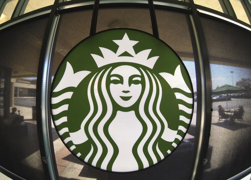The Starbucks logo hangs on a window inside a newly