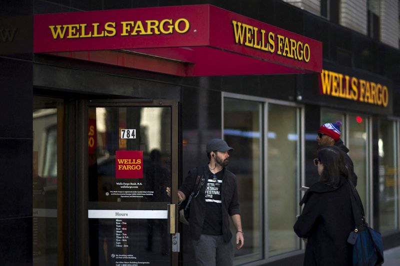 FILE PHOTO: People exit and enter Wells Fargo ATM in