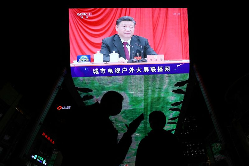 Giant screen shows Chinese President Xi Jinping attending the sixth