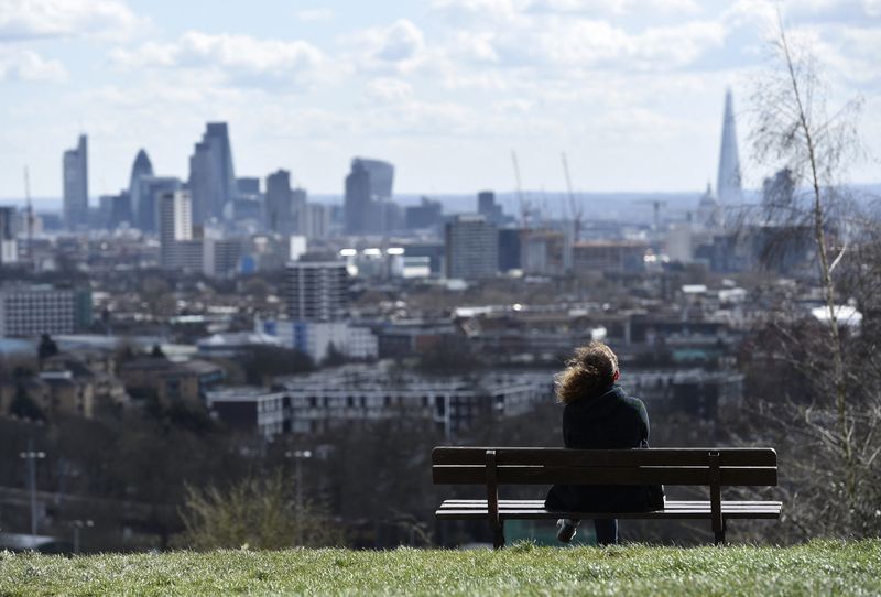 A woman looks towards the City of London financial district
