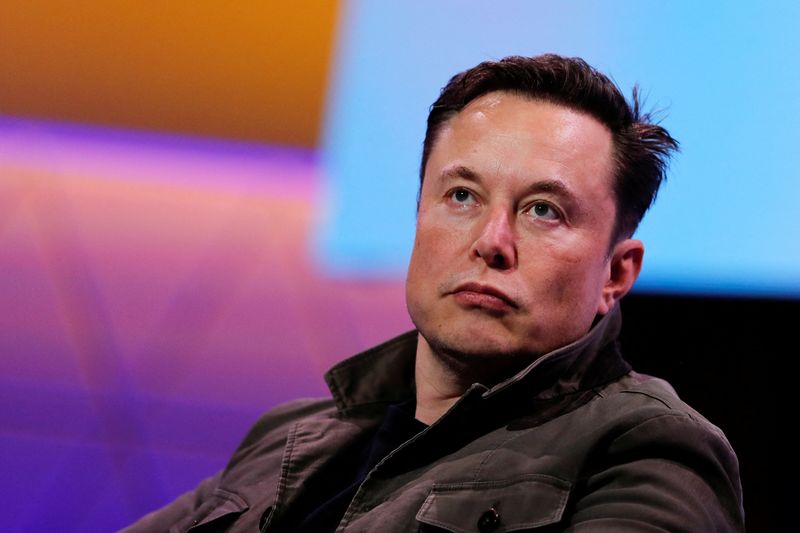 FILE PHOTO: SpaceX owner and Tesla CEO Elon Musk listens