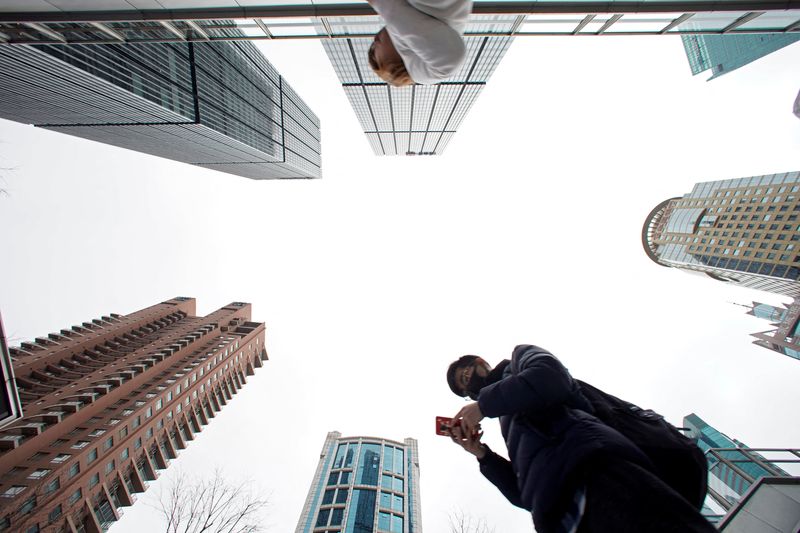 A man checks phone at Lujiazui financial district in Pudong