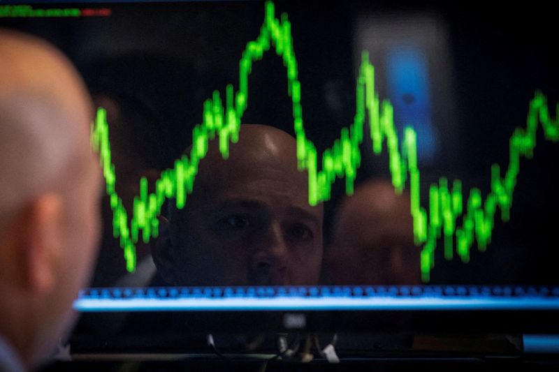 FILE PHOTO: A trader watches his chart while working on