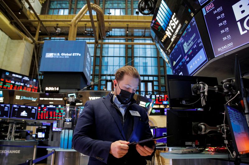 A trader works on the floor of the NYSE in