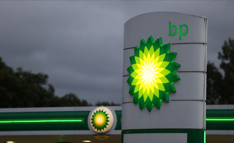 An illuminated BP logo is seen at a petrol station