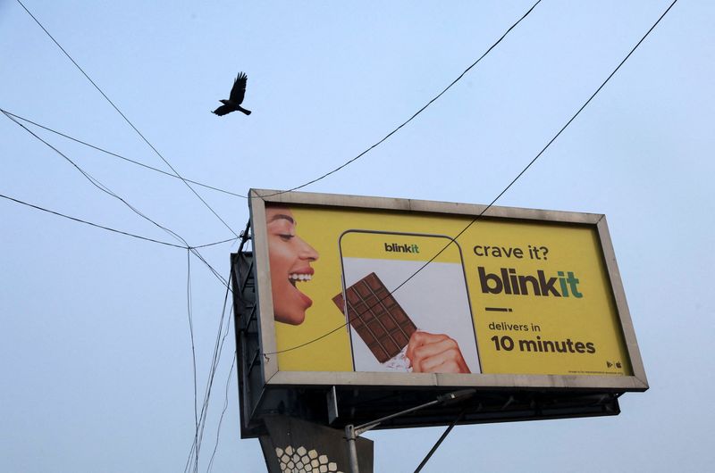 A bird flies over a hoarding featuring an advertisement of