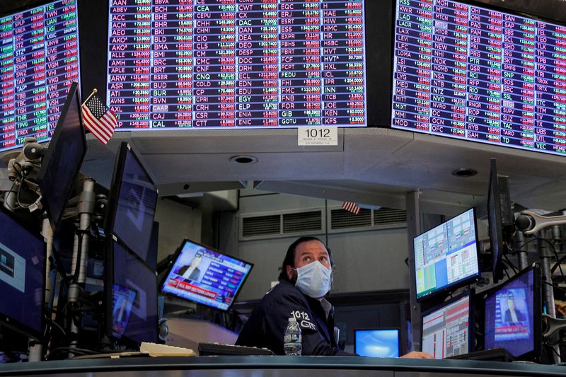 FILE PHOTO: Traders work on the floor of the NYSE