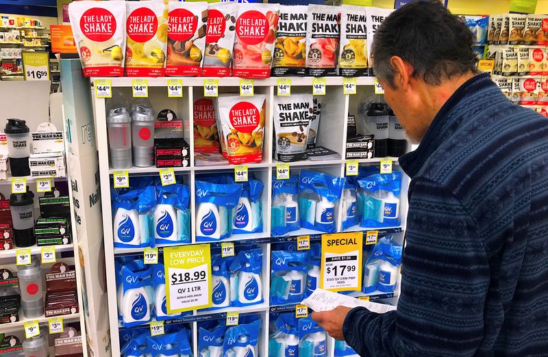A customer looks at products marked with discounted prices on