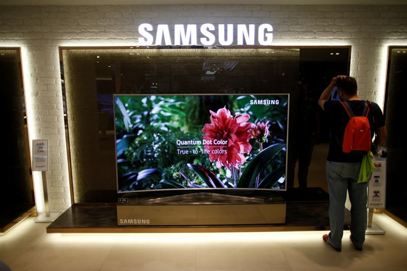 A man stands next to a Samsung Electronics “Quantum Dot”