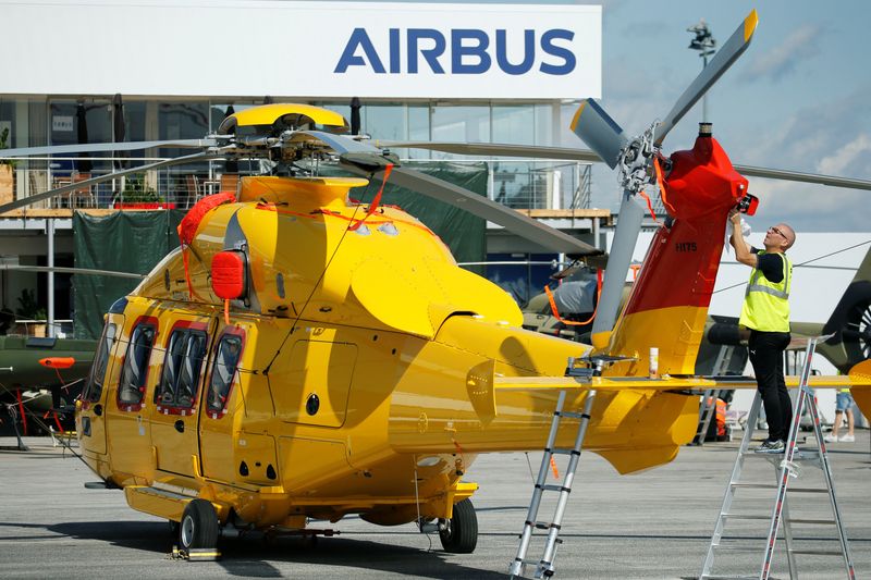 A worker cleans up a H175 Airbus helicopter on the