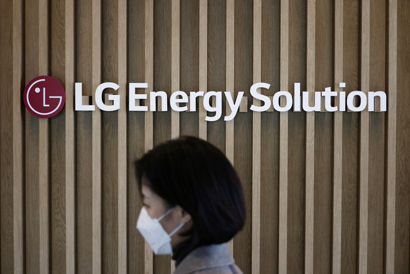 An employee walks past the logo of LG Energy Solution